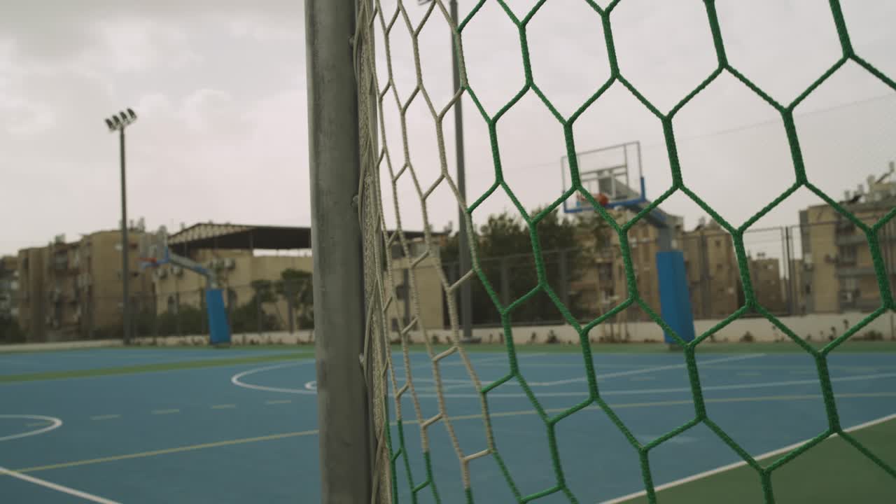 Net in a goal arc in local soccer field - outdoor court in school