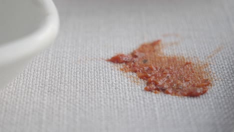 red sauce stain on a white cloth