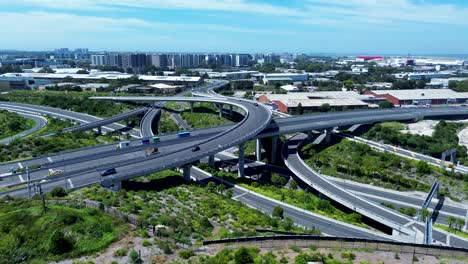 Drone-aerial-pan-of-roads-cars-driving-on-overpass-bridge-near-Sydney-airport-CBD-skyline-Alexandria-Tempe-infrastructure-Australia