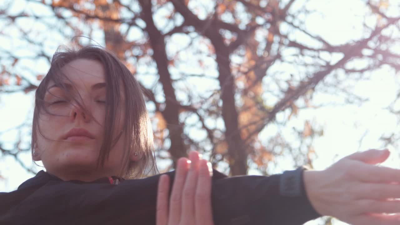 Woman Stretching Outdoors in Autumn