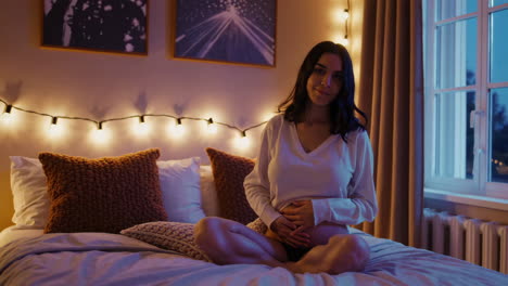 pregnant woman relaxing in bedroom