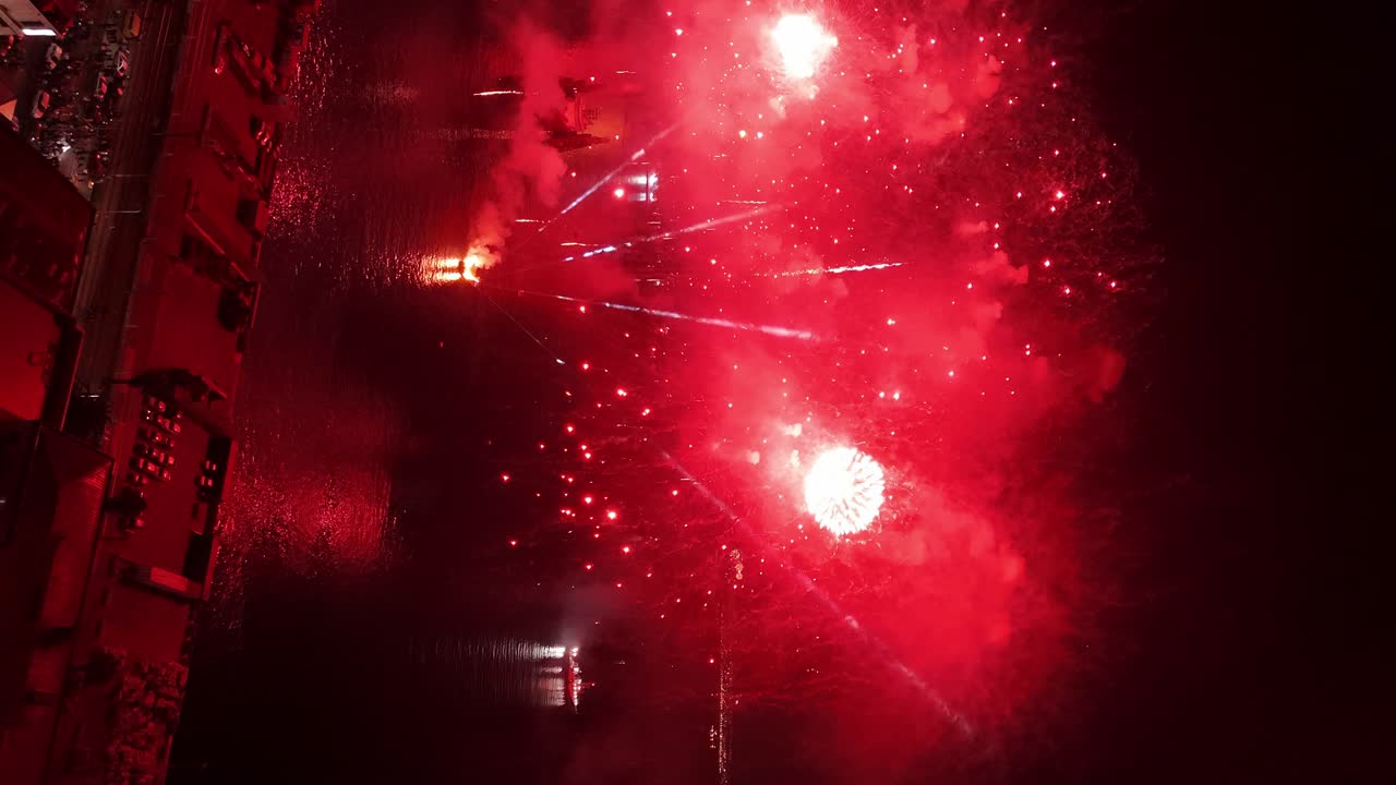 Vertical aerial view of continuous red flashes - New Year's Eve fireworks in Valapara&iacute;so Chile