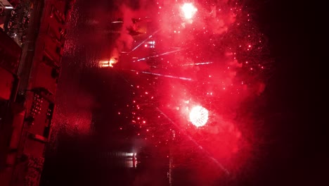 Vertical-aerial-view-of-continuous-red-flashes---New-Year's-Eve-fireworks-in-Valaparaíso-Chile