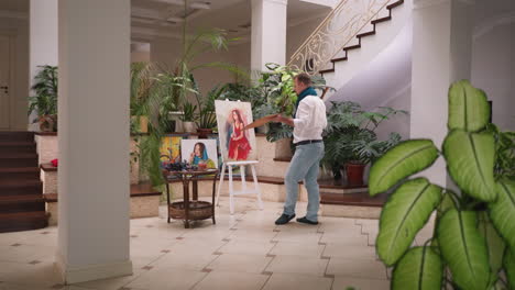 el pintor trae movimiento al estudio de arte. el artista permite que el pincel siga el flujo de la danza que resulta en la pintura. forma de autoexpresión del maestro