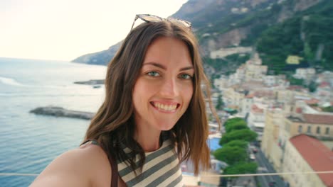 4k video footage of a young woman making a video call from an apartment balcony in italy on vacation