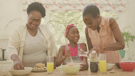 sand on the beach against african american grandmother, mother and granddaughter baking together