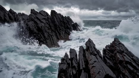 powerful waves crashing against dark rocks