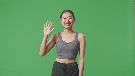 woman in sportswear waving