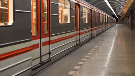 empty metro train arriving on deserted underground subway station terminal, slow motion