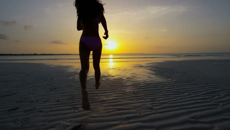 carefree asian chinese girl on ocean beach vacation