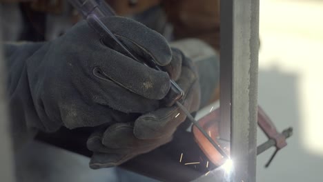 Stick-Welding-Slow-Motion,-Close-Up-Of-Gloved-Hands-Holding-Welder