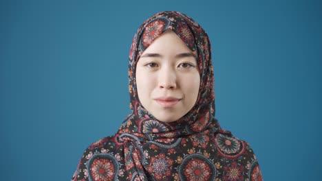 happy smiling asian muslim young woman in hijab.