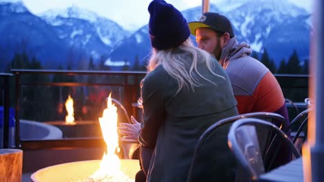 couple interacting nearby campfire