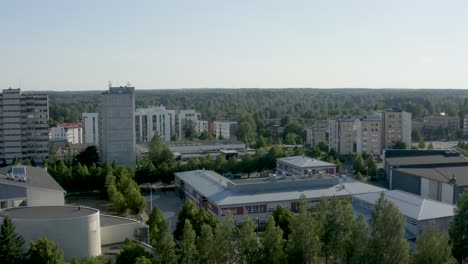 Slow-aerial-pan-of-two-large-towers-with-buildings-below-in-Finland