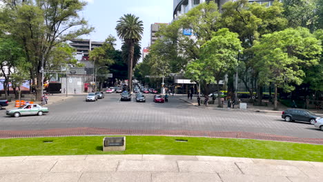 scene of vehicles circulating through the roundabout of the angel of independence in the paseo de la reforma in mexico city