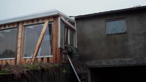 carpentry work with a man building a diy greenhouse