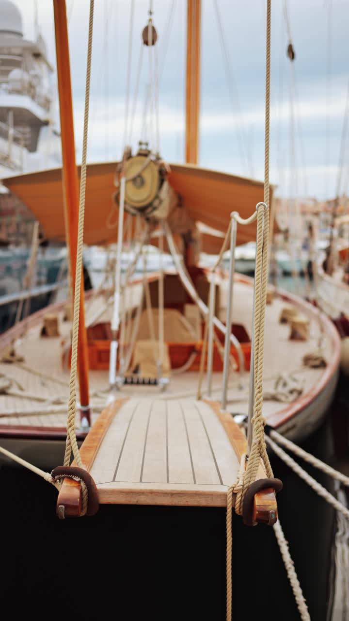 Wooden boat docked in the Port of Cannes, France in daylight. Vertical