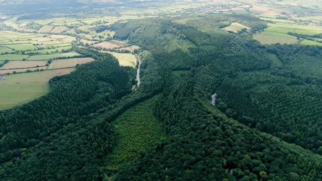 Aerial-establishing-view-of-the-Tamar-River-winding-through-dense-woodland-in-the-picturesque-countryside-of-Devon-and-Cornwall