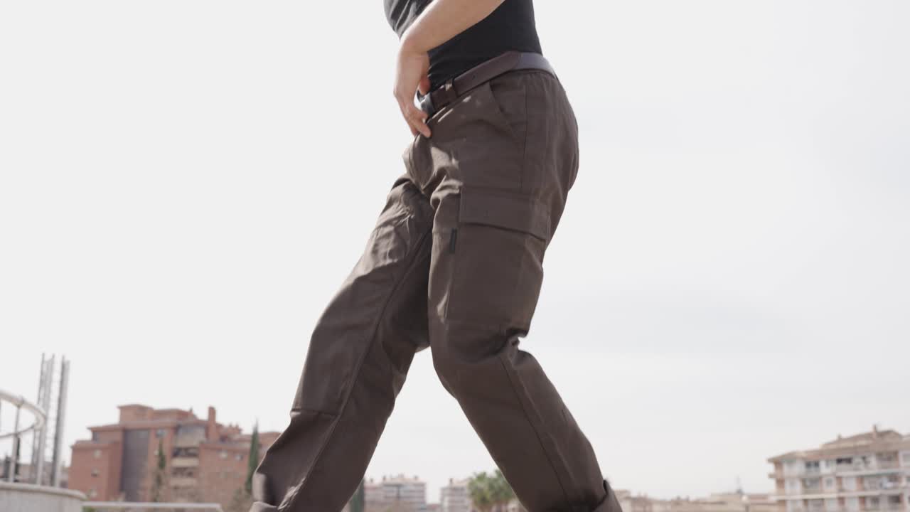 Energetic male dancer performing modern choreography outdoors