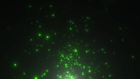 pequeñas partículas verdes y estrellas en fondo oscuro