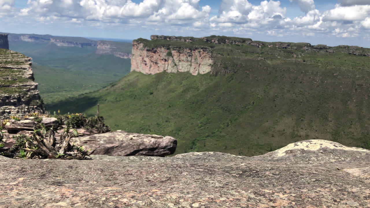 Steps, Boots passing by with amazing stone mountains at the background under blue sky