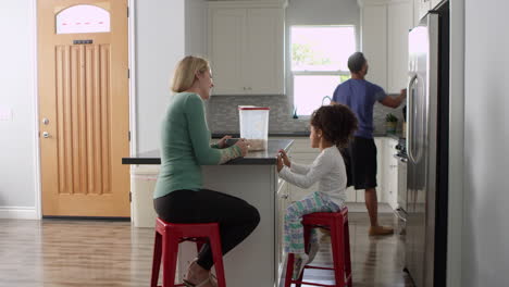 Mixed-race-couple-and-daughter-talk-in-kitchen,-full-length,-shot-on-R3D