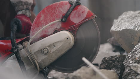 worker operating a concrete road cutter at roadworks