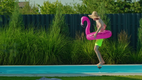 man having fun at a swimming pool with an inflatable flamingo