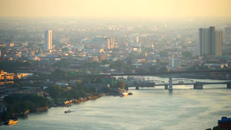 boats in chao phraya river at sunset in bangkok city, thailand.