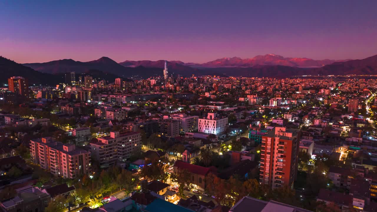 Panoramic Aerial Hyperlapse Fly Above Barrio Italia Santiago, Chile at Sunset Time, City Neighborhood, Andean Cordillera and Architecture with Vibrant Blue and Pink Tones