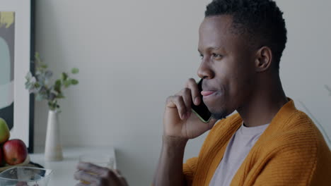 man talking on phone at home