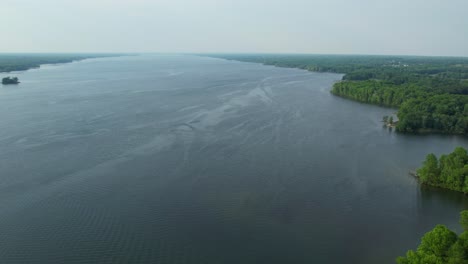 An-aerial-view-of-a-forest-of-the-Allegheny-National-Forest-and-the-Allegheny-Reservoir-in-Warren,-Pennsylvania,-USA-on-a-sunny-spring-day