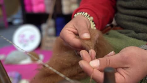a street artist sewing manufacturing with traditional spinning wheel