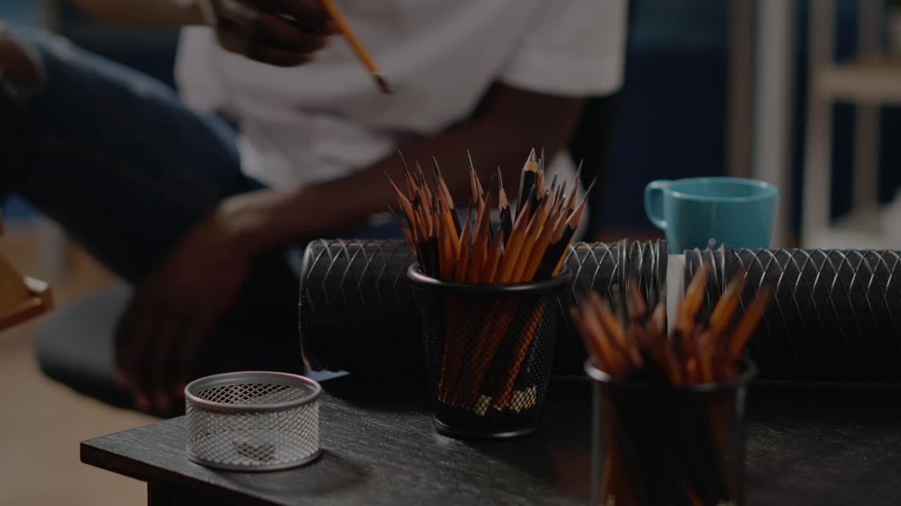 Close up of art tools and colorful pencils on workshop table