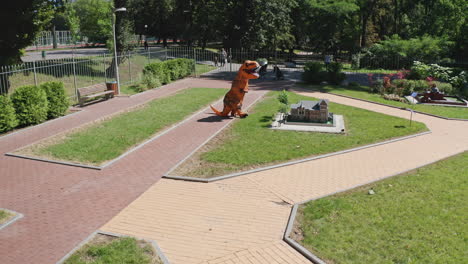 dinosaur costume in a miniature city park