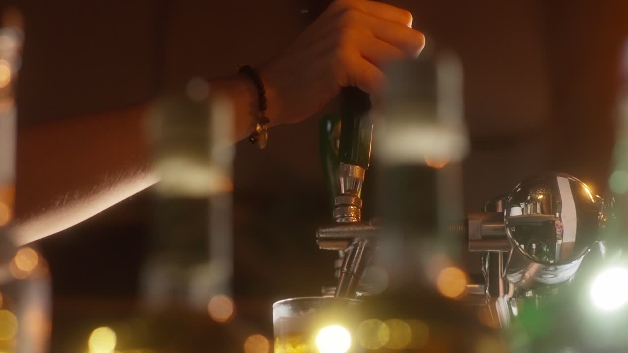 Golden beer pouring smoothly from a beer dispenser into a glass at a lively bar setting
