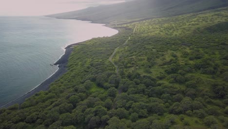 Aerial-footage-of-a-cmapervan-driving-along-the-open-coastline