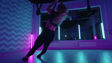 Woman-hanging-upside-down-and-using-yoga-hammock-swing-while-doing-antigravity-yoga-exercise.-Back-view-of-beautiful-young-woman-using-hammock-for-doing-pose-of-antigravity-yoga