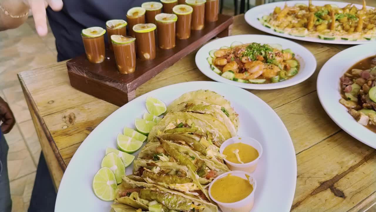 Shrimp and seafood buffet served on wooden table during meeting, shrimp tacos in foreground