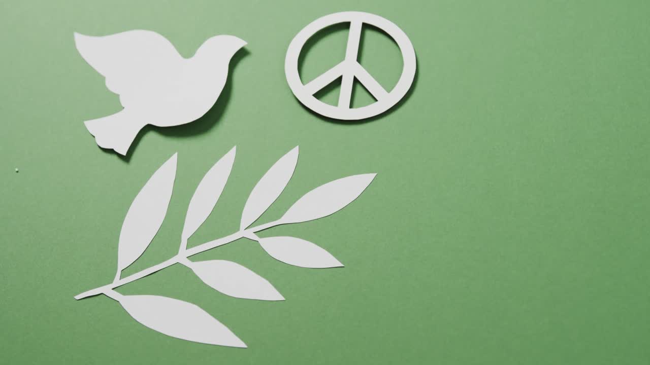 평화 기호 와 잎 과 녹색 배경 에 있는 복사 공간 을 가진  ⁇  비둘기 의 클로즈업