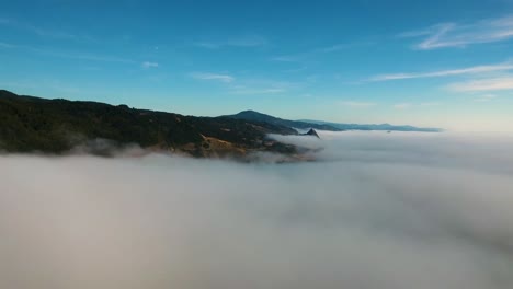 AERIAL:-Flying-over-a-layer-of-fog-the-Oregon-coastline-begins-to-be-visible