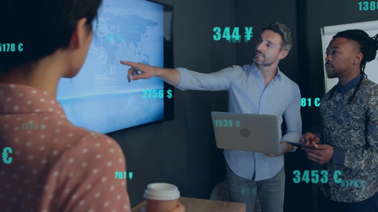 Presenter pointing at wall map, initiating teal currency overlays while team analyzing finance data