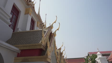 walking around an important and traditional thai buddhist temple in bangkok filming the roof details of gold