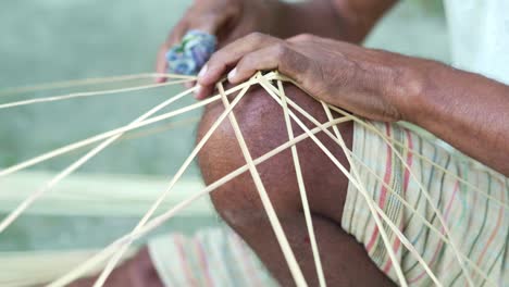 indian-close-up-on-male-hands-master-weaves-baskets-from-wooden-sticks