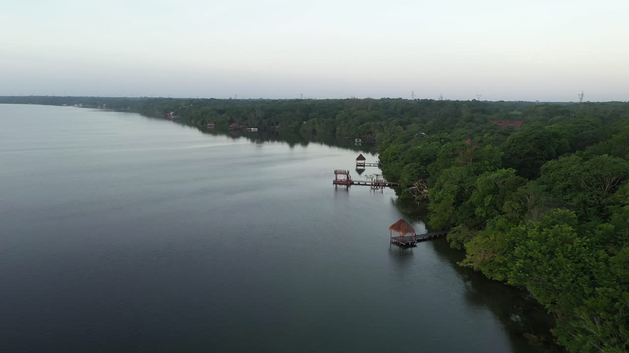 Aerial View of a Calm Lake with Lush Greenery and Gazebos