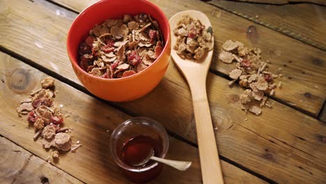 Wheat-flakes-and-honey-on-wooden-table-4k