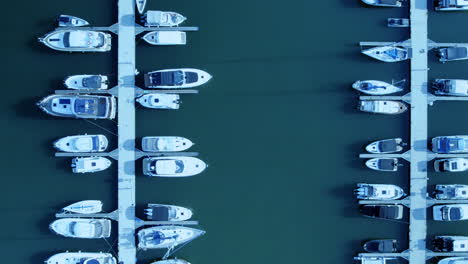 aerial bird's eye view tracking along speed boats in pier