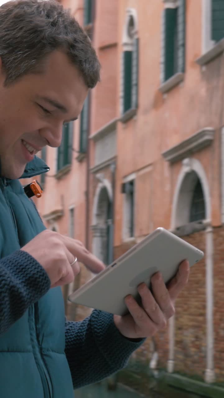 Man using tablet while traveling in a city