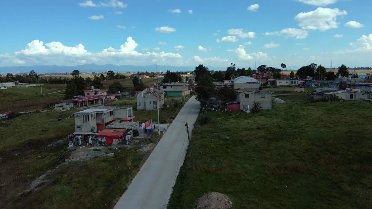 Bird's eye view of rural brick houses in Almoloya in the state of Mexico with ample land for planting