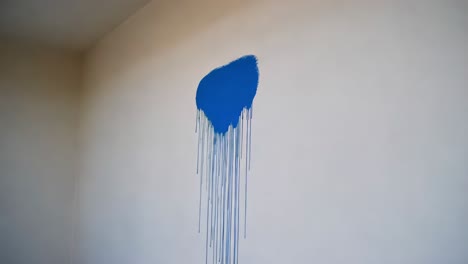 blue paint drips on wall